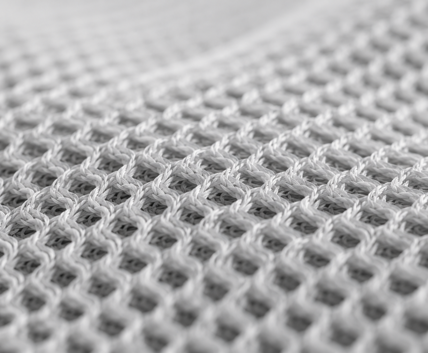 Soft white open-knit structure illustrating breathable baby-contact material construction