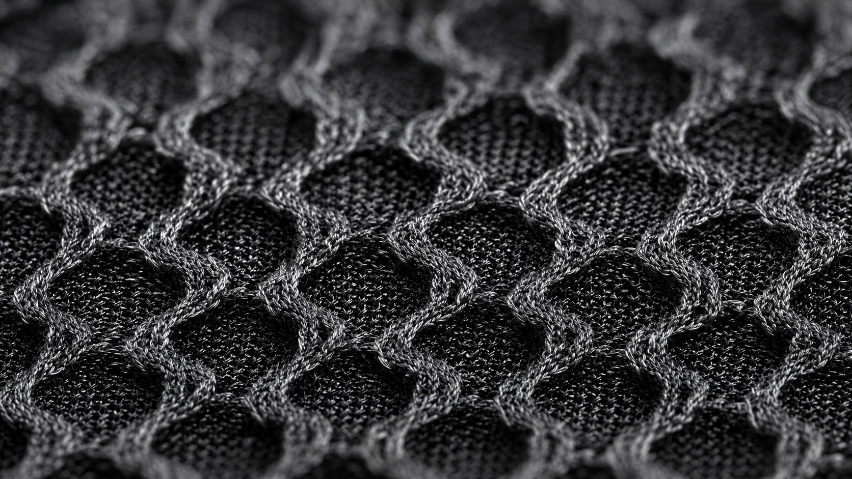 Dense black honeycomb knit structure supporting airflow in close-to-skin apparel